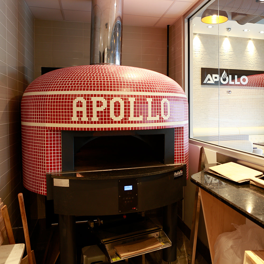 A red Napoli fired oven with a custom branded tiling for Apollo.