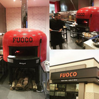 A bright red Napoli fired oven with a custom branded tiling for Fuoco.