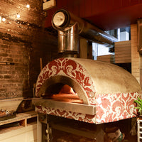 A Roma fired oven with a white and red pattern tile finish.