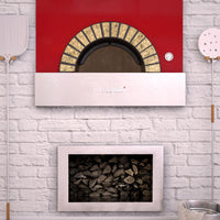 Milano fired oven with a red finish enclosed within a decorated brick wall.